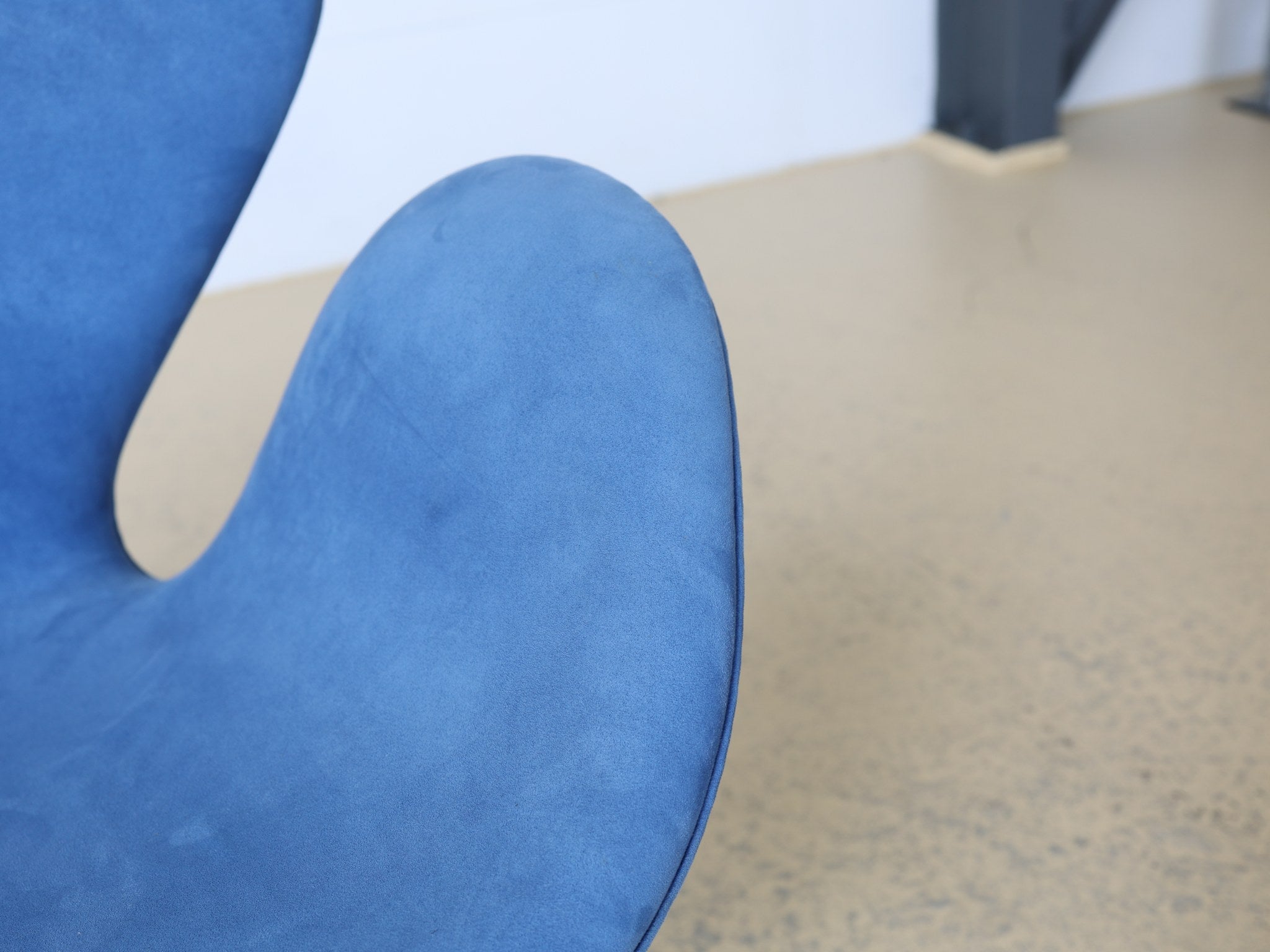 Detail der organischen Rückenlehne des Swan Chair in Alcantara hellblau