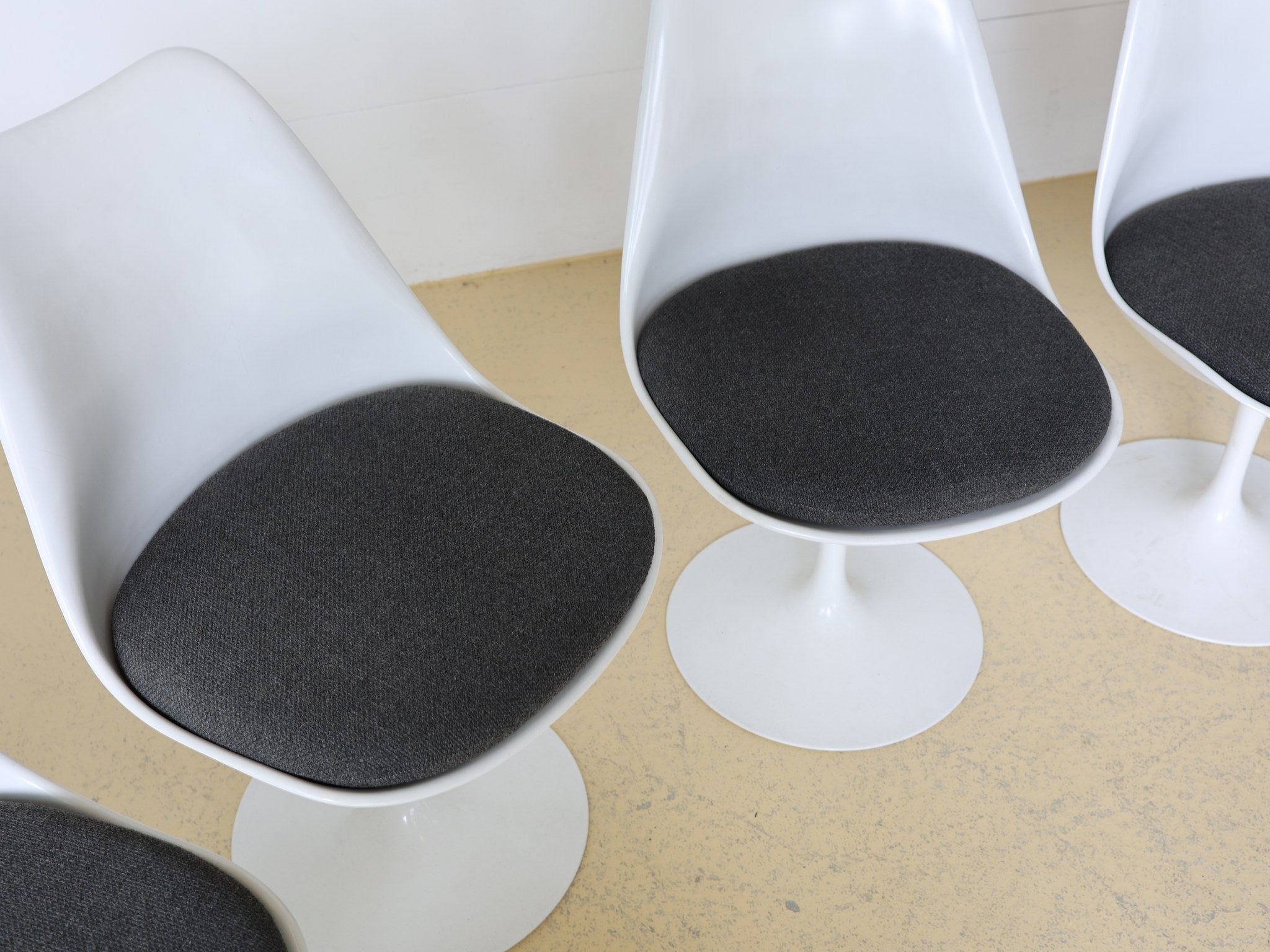 Acht Tulip Chairs von Eero Saarinen in Reihe aufgestellt
