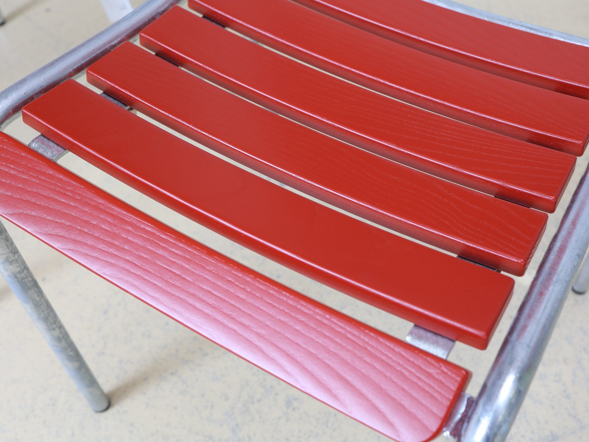 Set aus vier roten Schweizer Gartenstühlen, zwei mit und zwei ohne Armlehnen